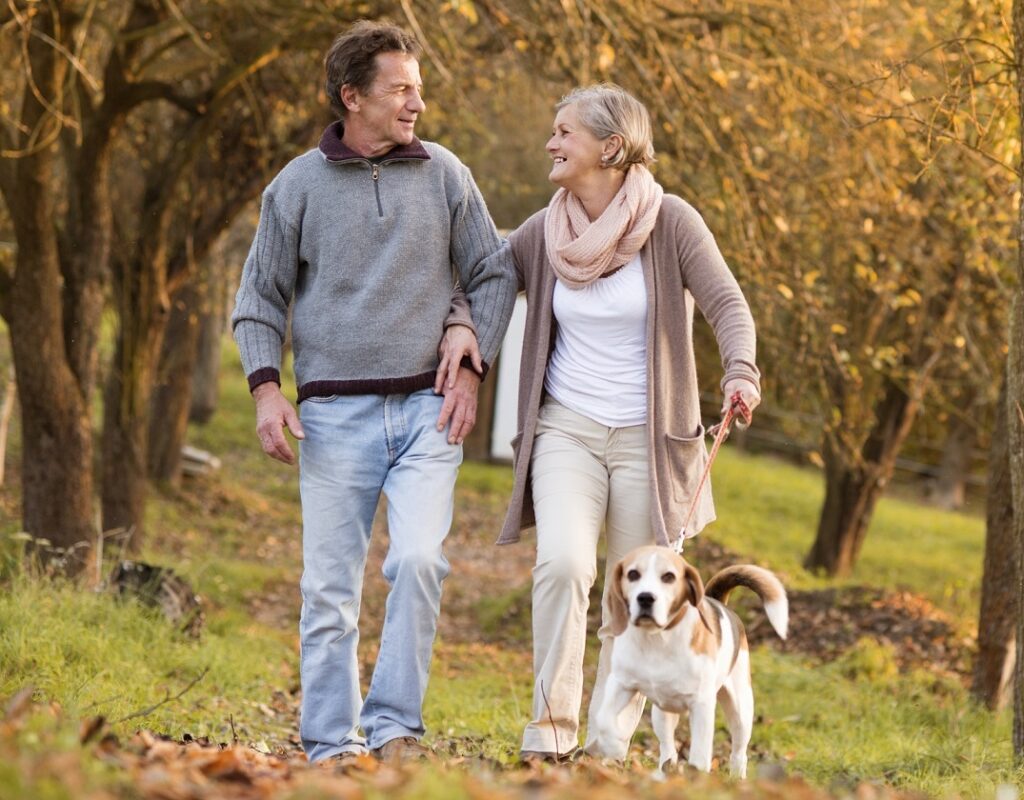 Healthy people being active walking with dog